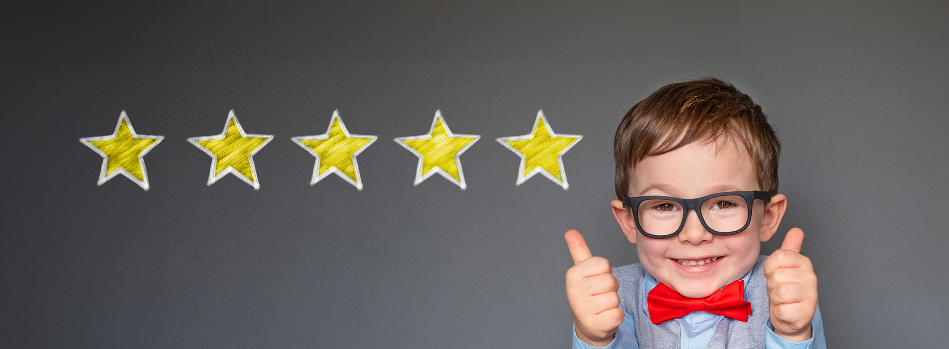A young boy giving a thumbs-up gesture with stars behind him.